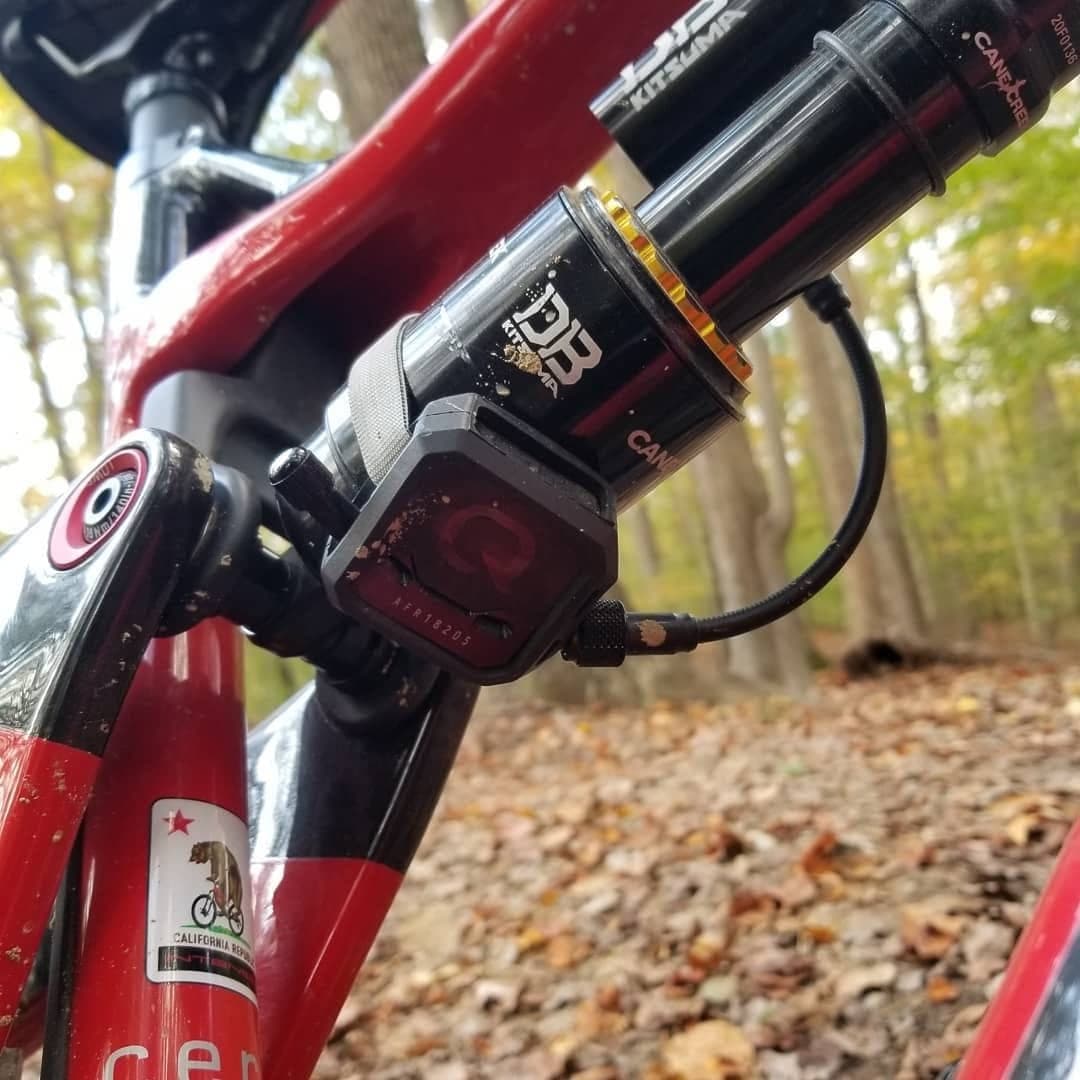 Coil rear shock mounted on a red mountain bike frame