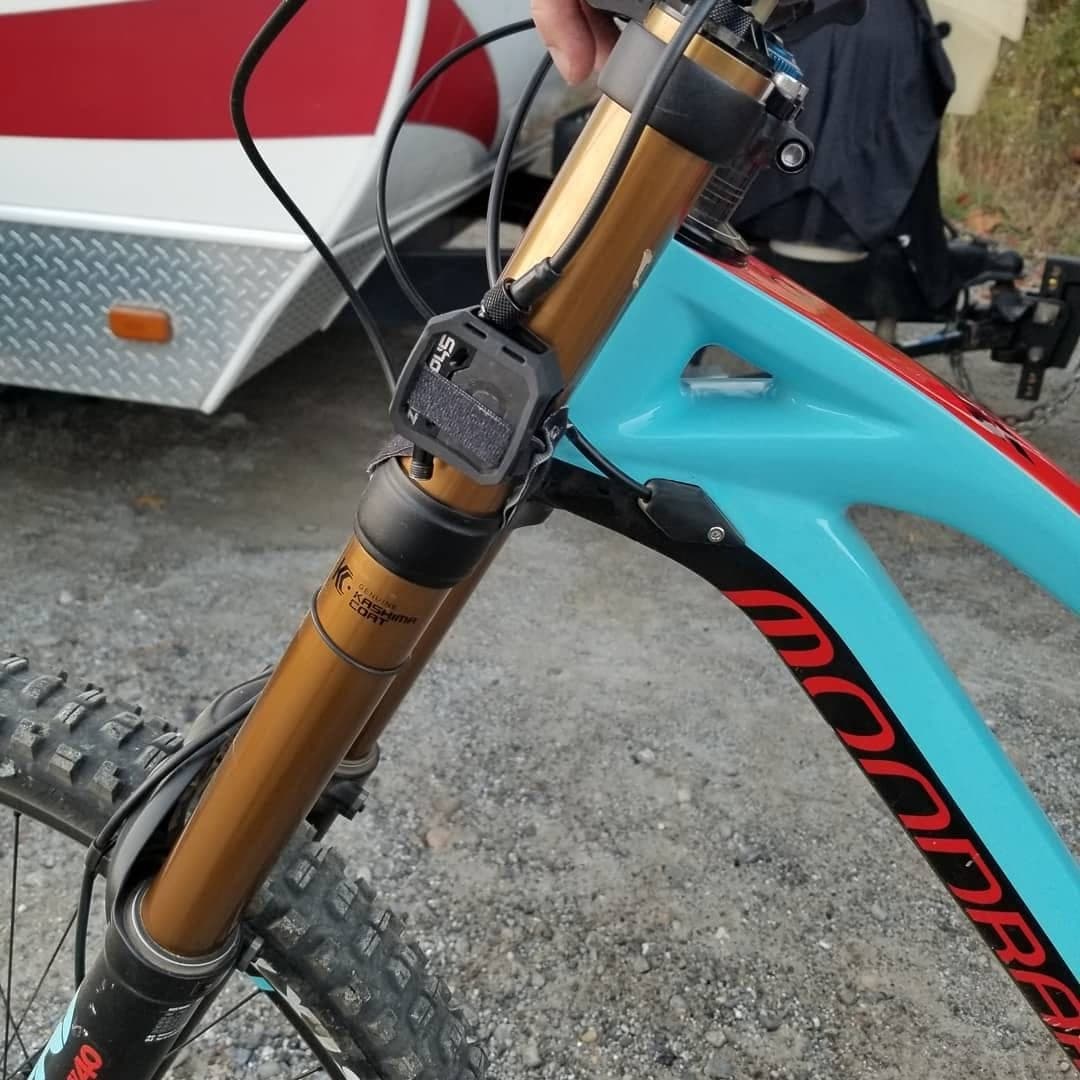 Close-up of a gold Fox fork being set up on a Mondraker